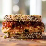 gochujang chickpea salad sandwich on the cutting board before slicing