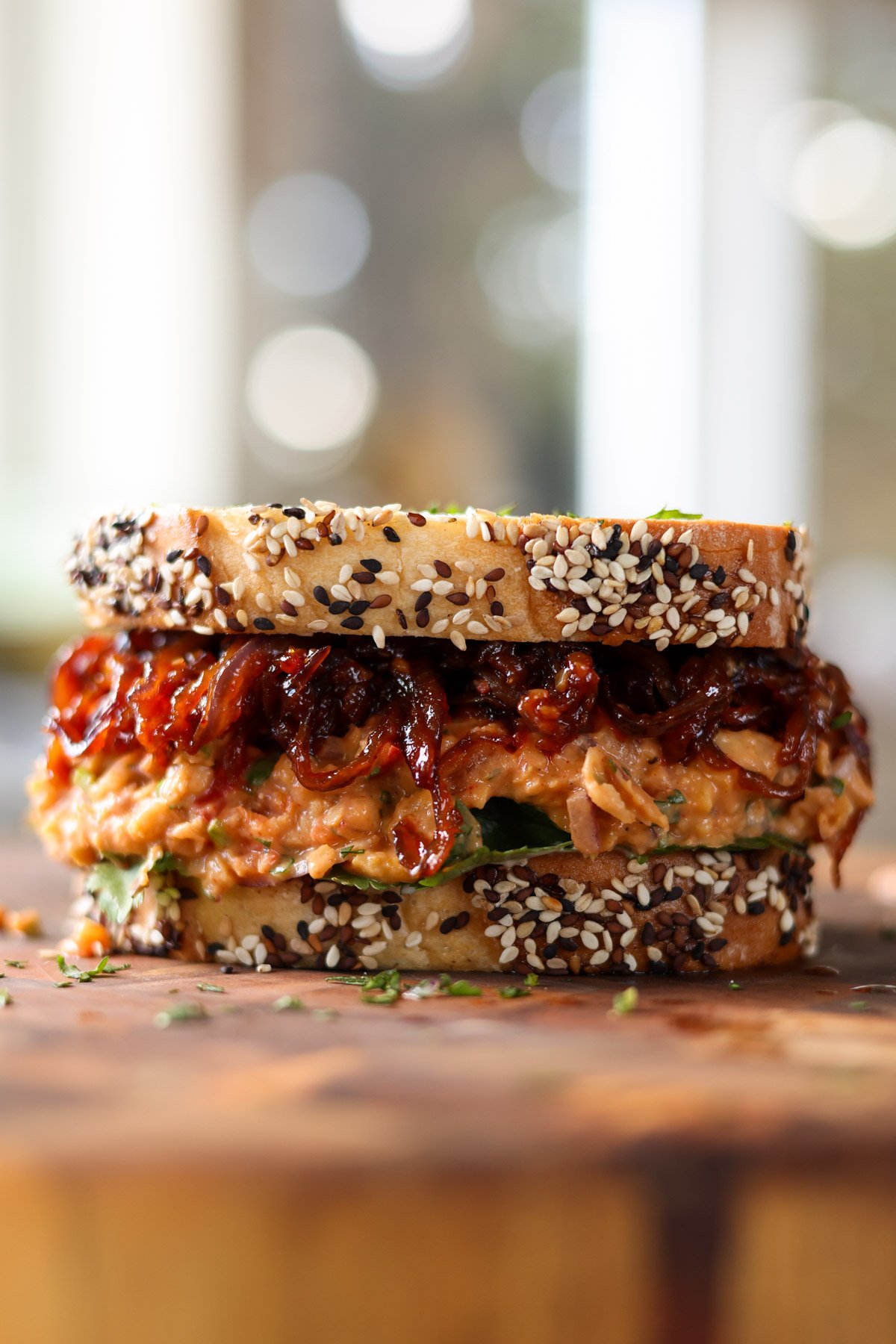 gochujang chickpea salad sandwich on the cutting board before slicing