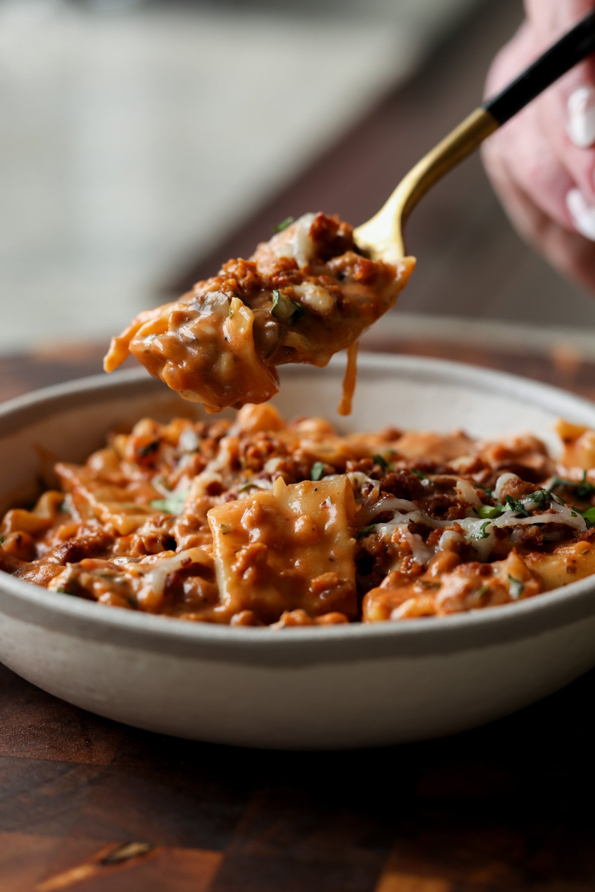 spooning a bite of creamy lasagna soup