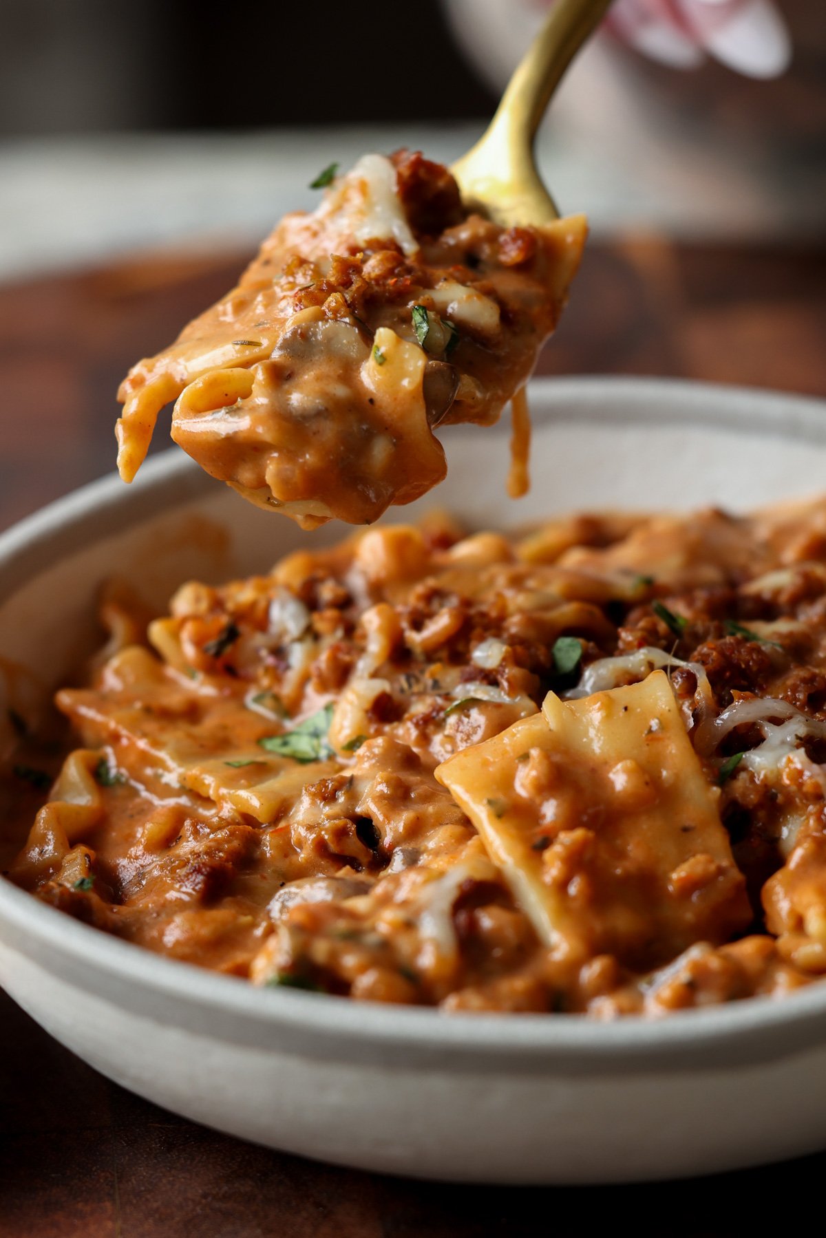 spooning a bite of creamy lasagna soup