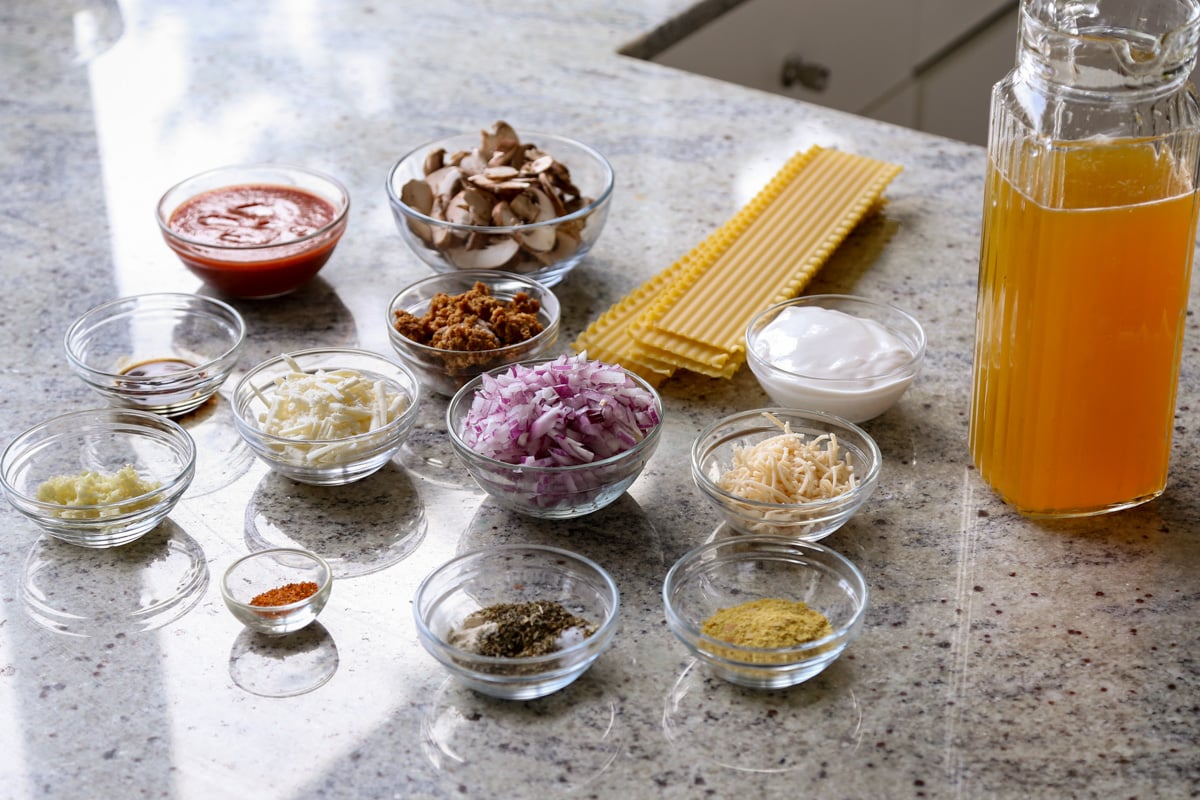 lasagna soup ingredients in bowls on a kitchen counter