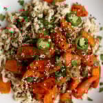shredded tofu topped with roasted carrots in a bowl