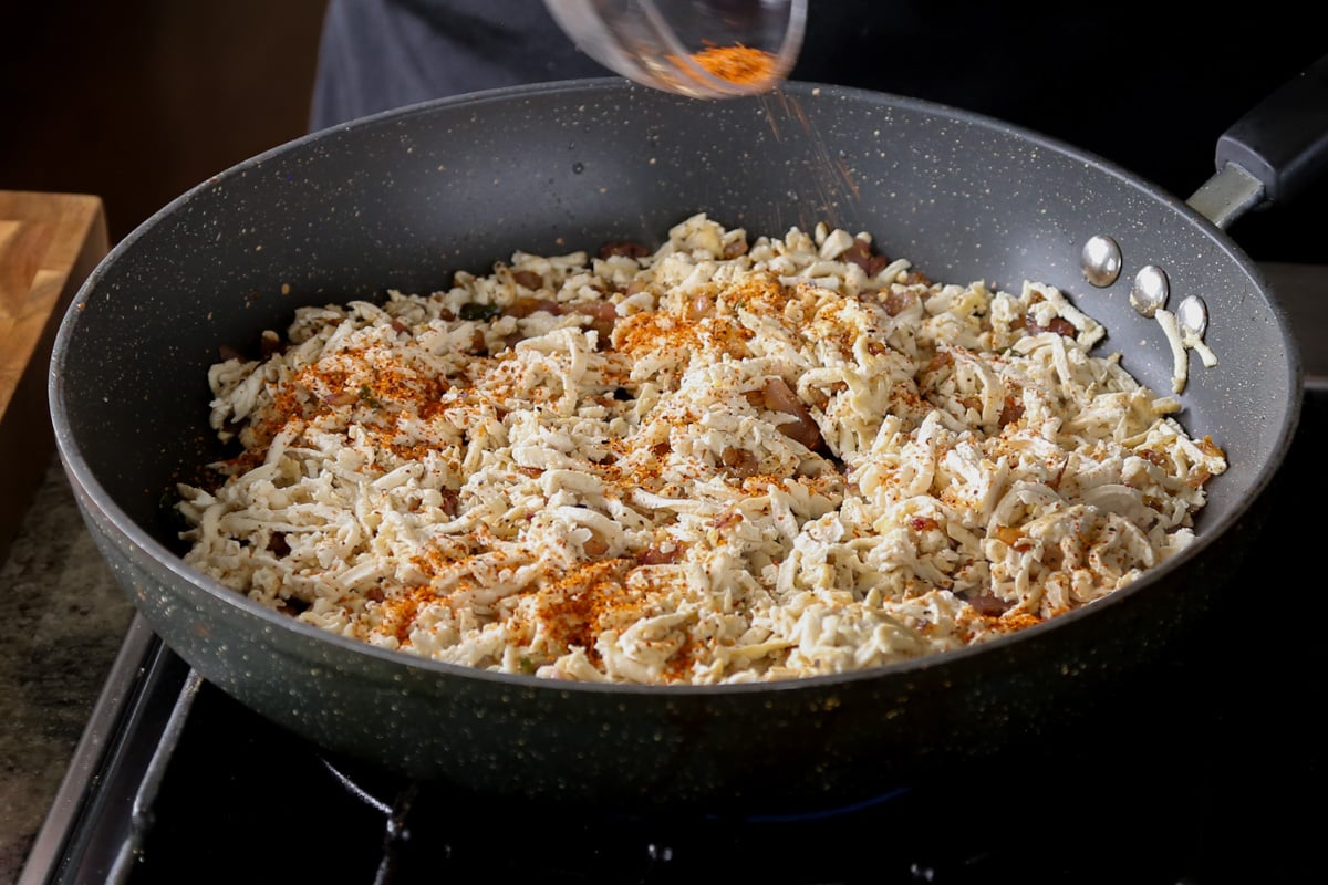 adding spices to the tofu