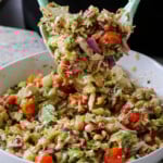 tossing the chopped Italian salad together with the dressing