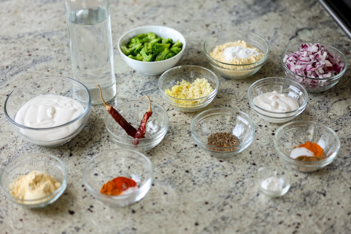 kadhi pakora ingredients in bowls on the counter