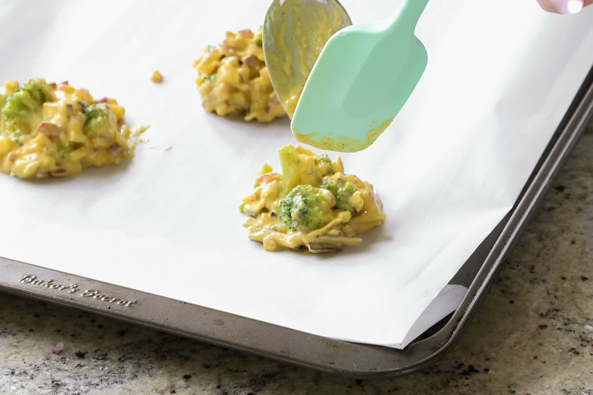 spooning pakora batter onto the baking pan