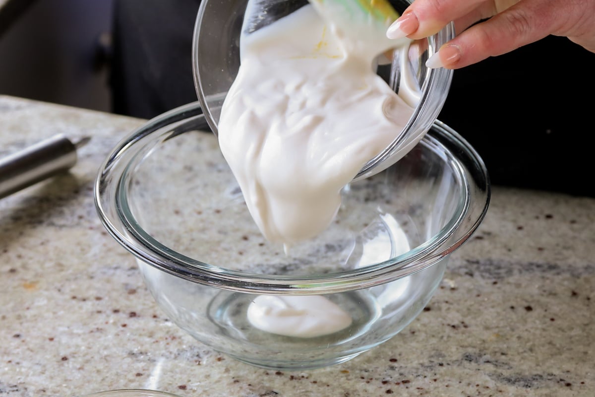 adding non-dairy yogurt to a bowl