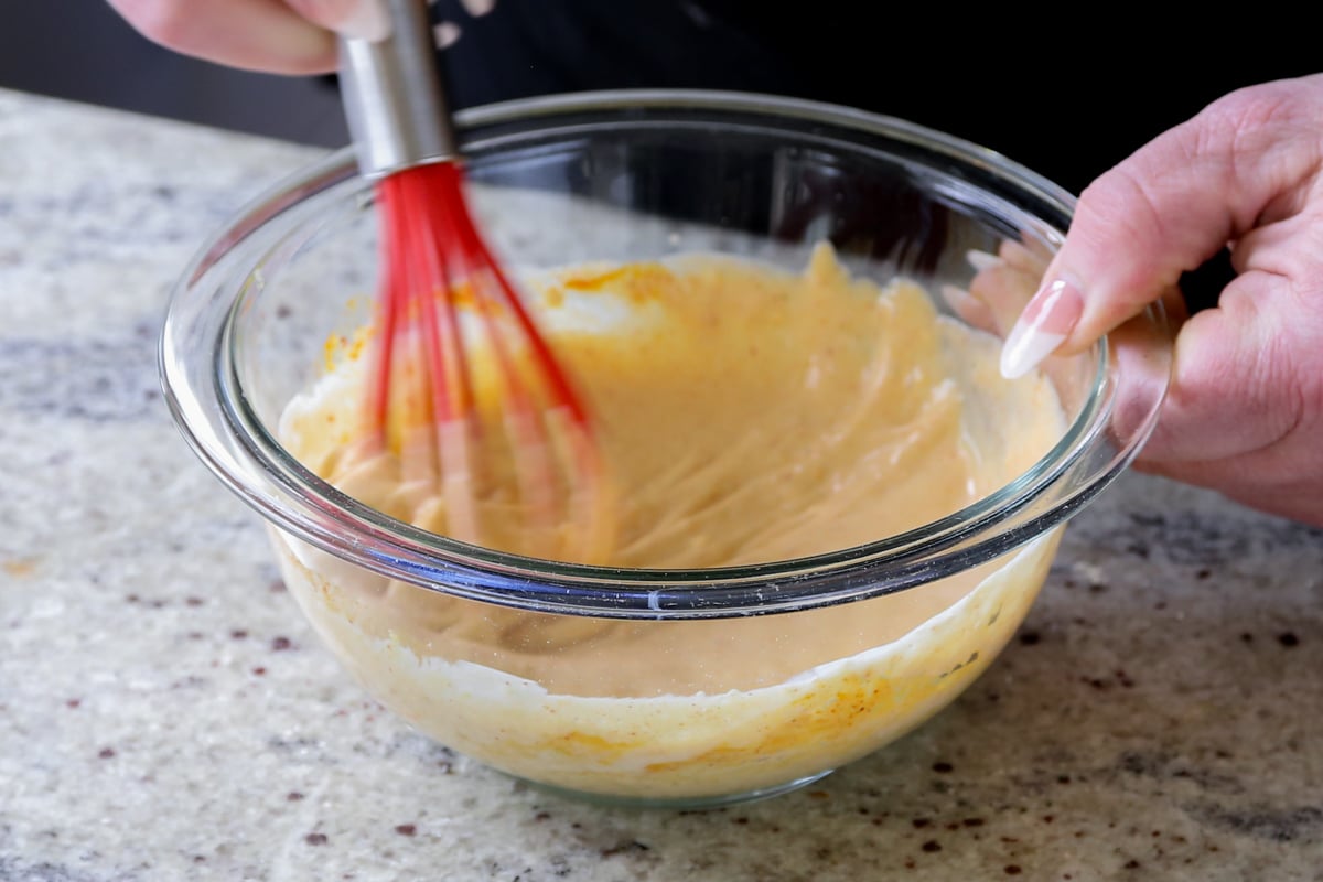 mixing together curry sauce ingredients in the bowl