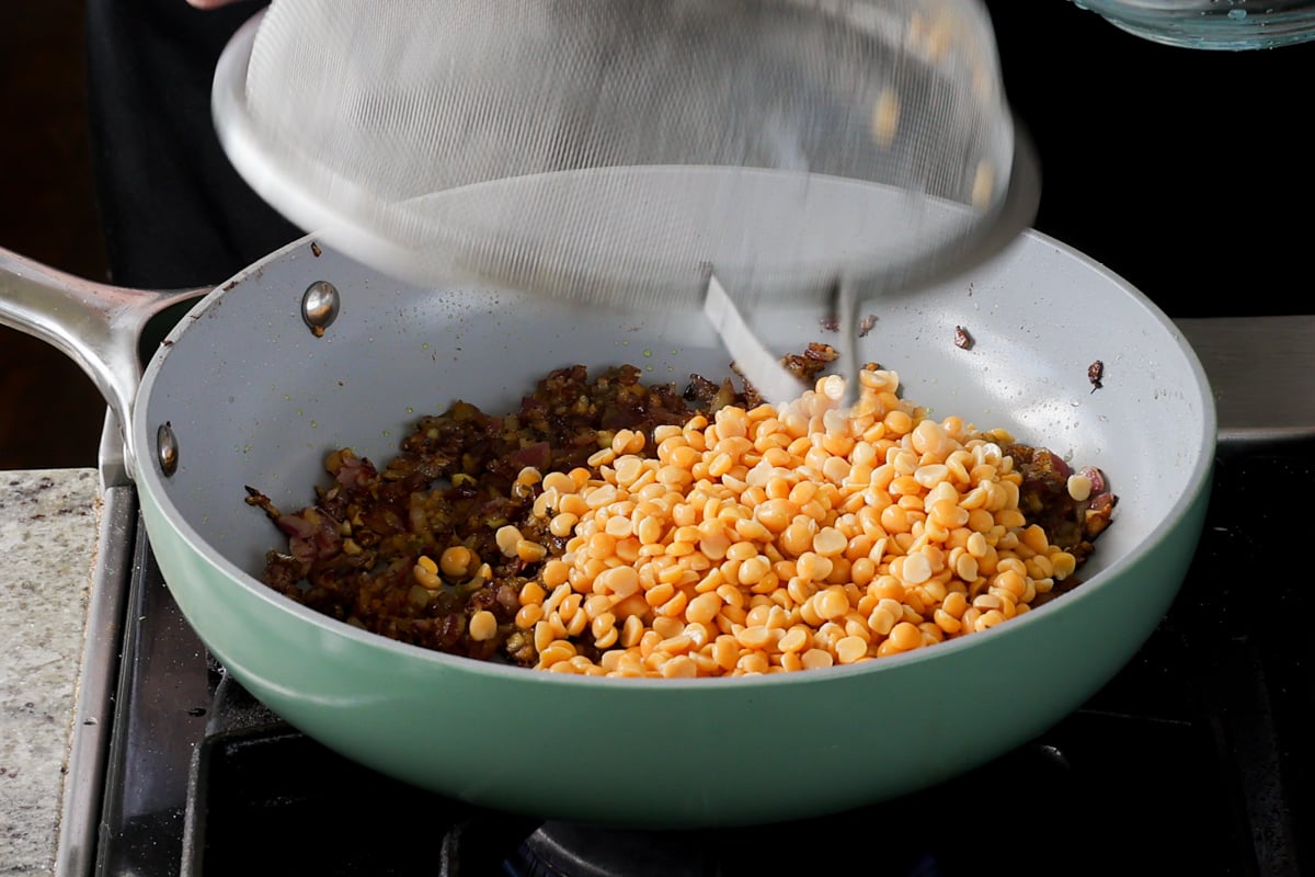 adding yellow split peas to the pan