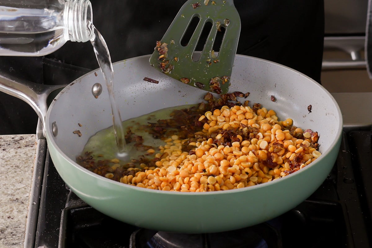 adding water to the pan