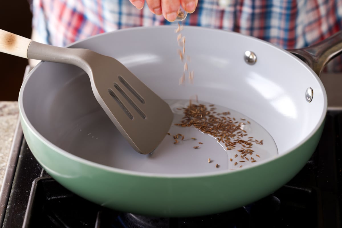 adding the whole spices to the pan