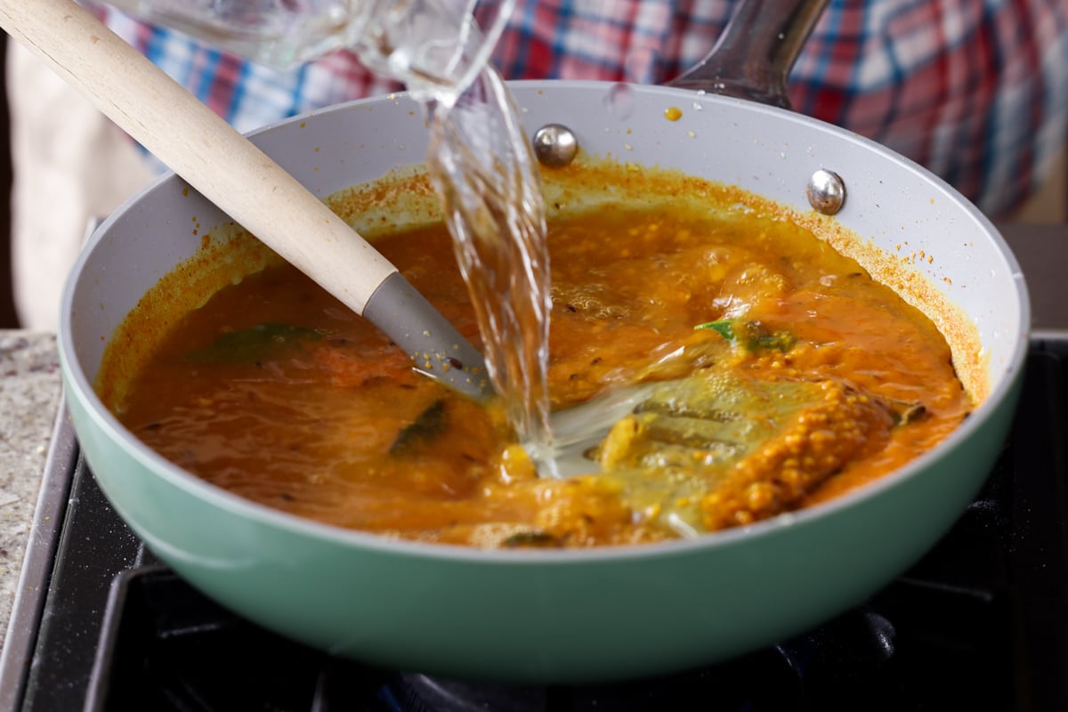 adding more water to the pan