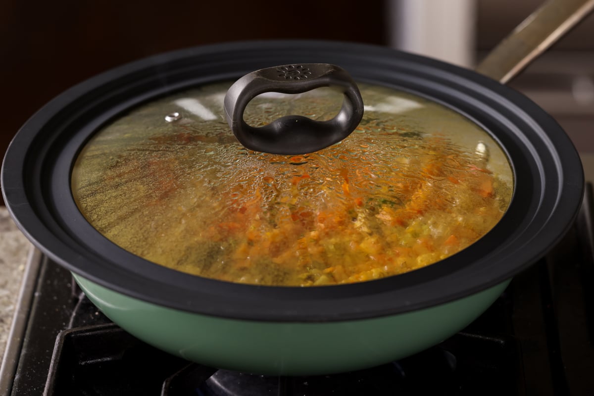 covered pan simmering on the stove