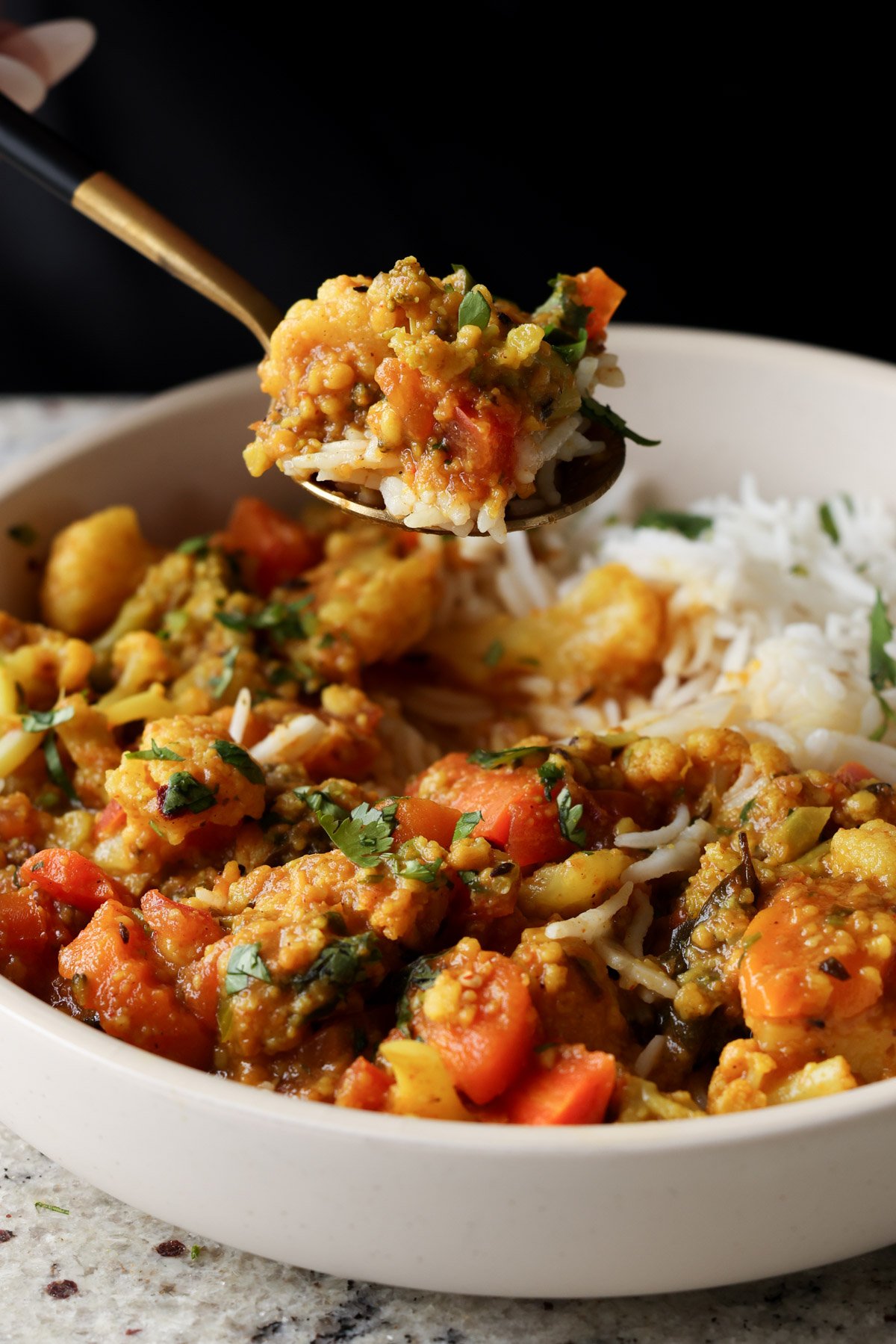 spoon taking a bite of Sindhi kadhi