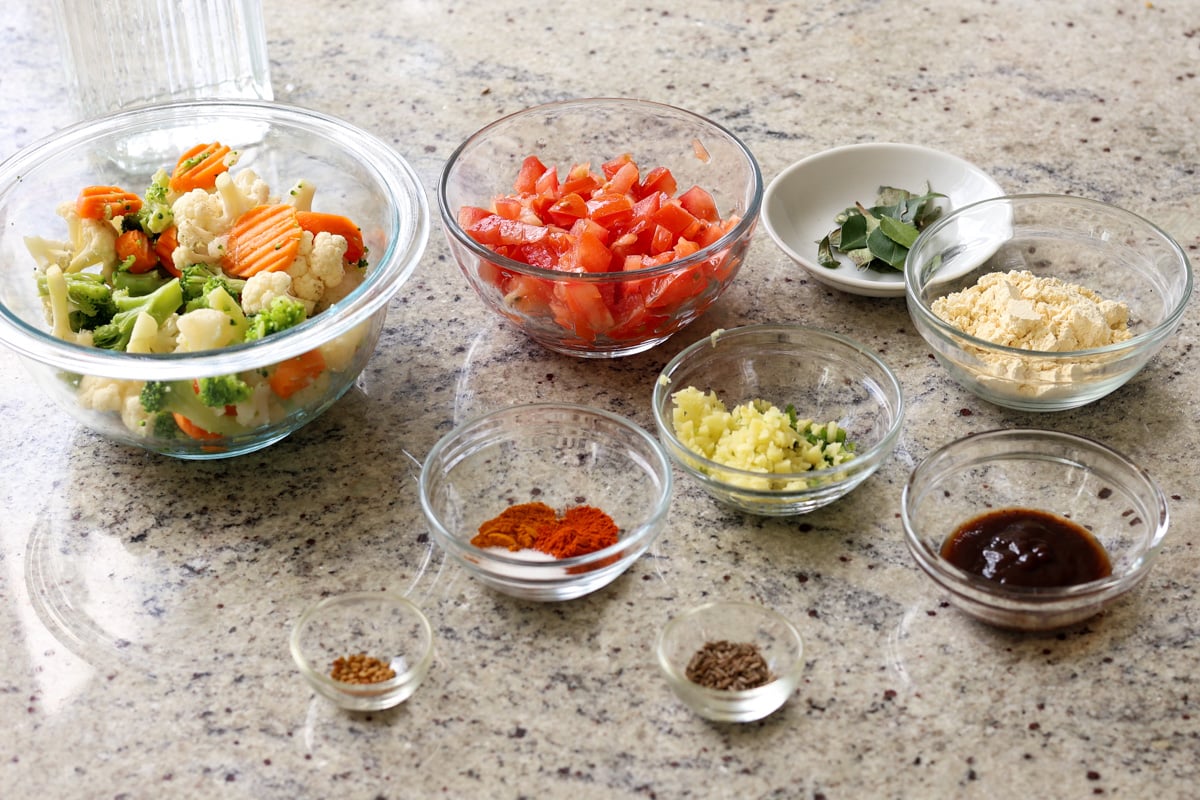 Sindhi kadhi ingredients in bowls on the kitchen counter