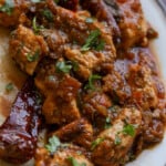 Chettinad pepper chicken curry on a plate with naan