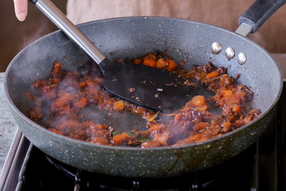 pressing the tomato, so it gets jammy