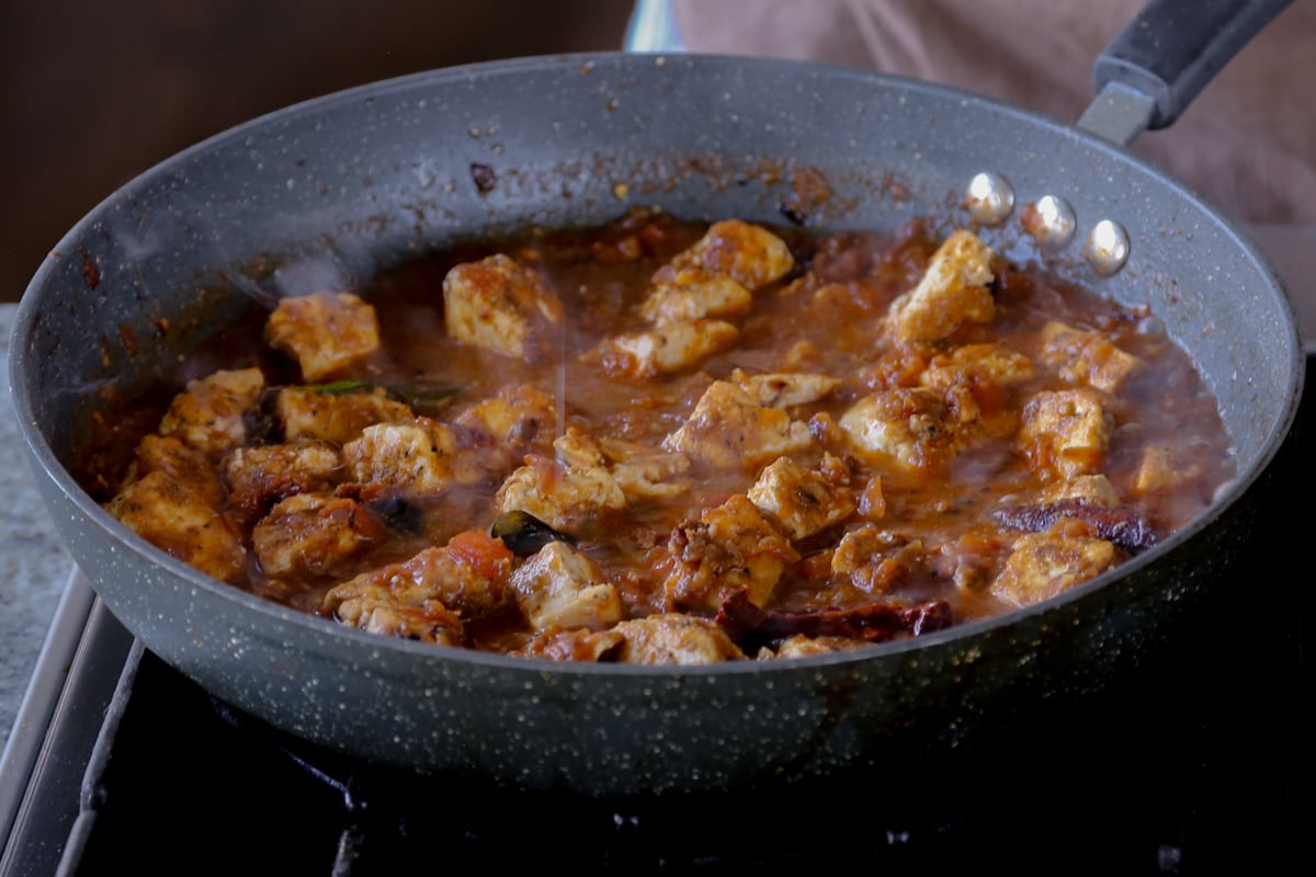 tofu folded into the Chettinad pepper chicken sauce in the pan