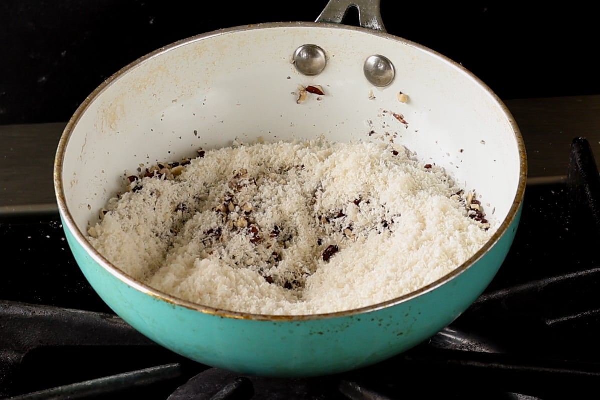 adding coconut to the pecans