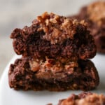 German chocolate cookie broken in half on a plate after baking, so you can see the filling