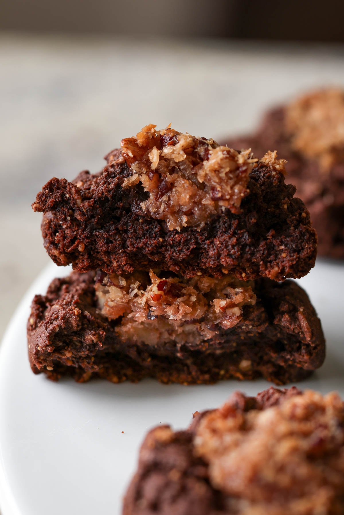 German chocolate cookie broken in half on a plate after baking, so you can see the filling