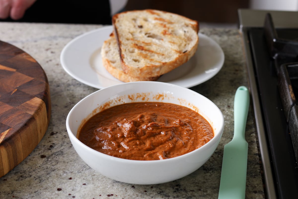 adding spread to the grilled bread
