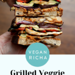 hands holding a sliced grilled veggie sandwich text overlay