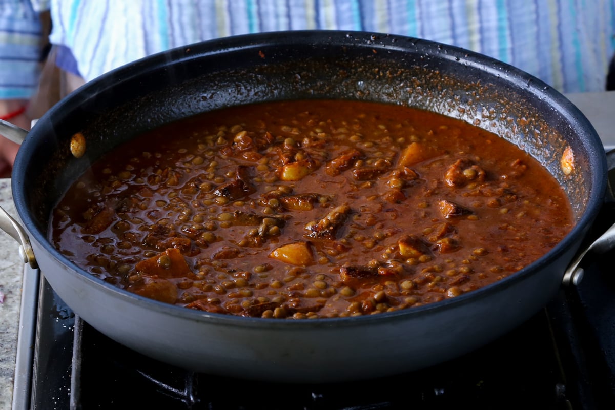 adding potatoes to the vindaloo sauce