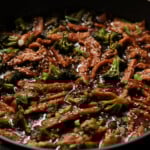 close-up of vegan beef with broccoli in the pan after adding garnishes