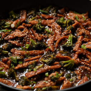 close-up of vegan beef with broccoli in the pan after adding garnishes