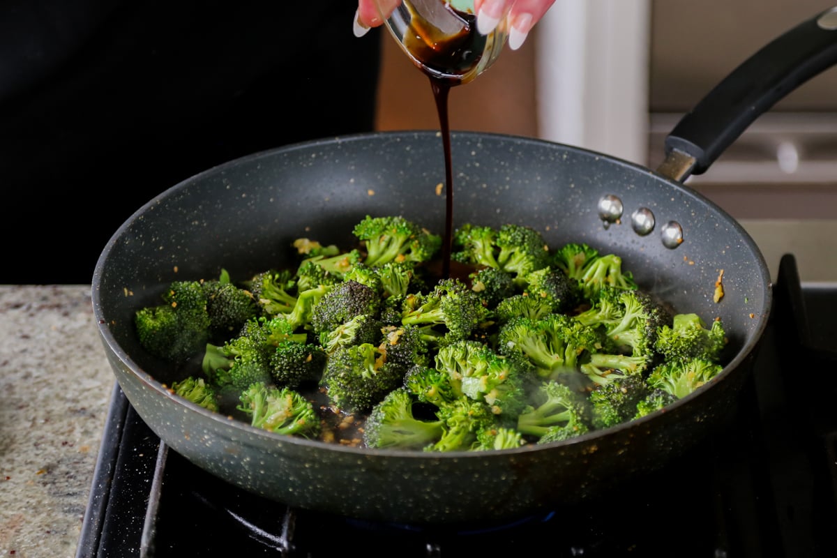 adding dark soy sauce to the pan