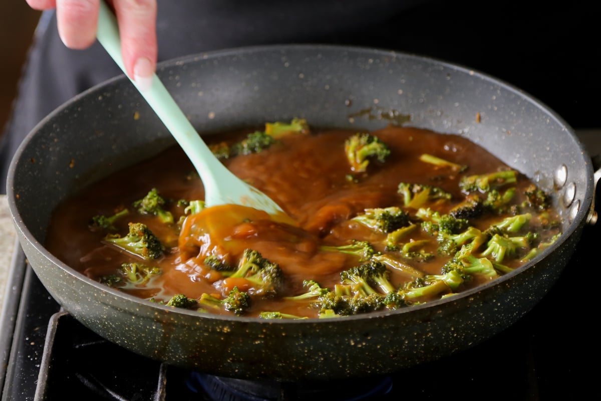 adding cornstarch mixture to the broccoli in the pan