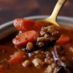 spoon taking a bite of veggie bean stew