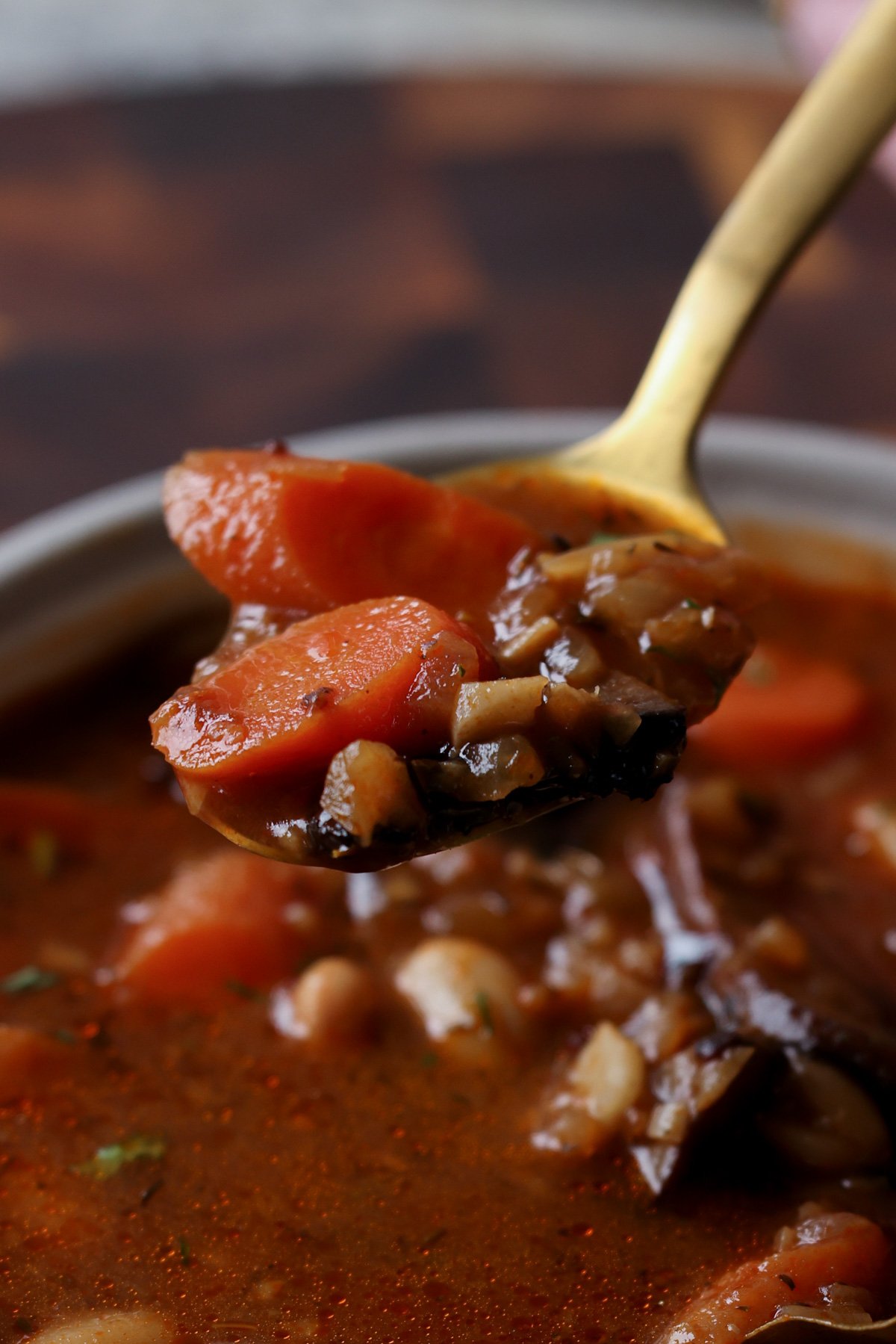 spoon taking a bite of veggie bean stew