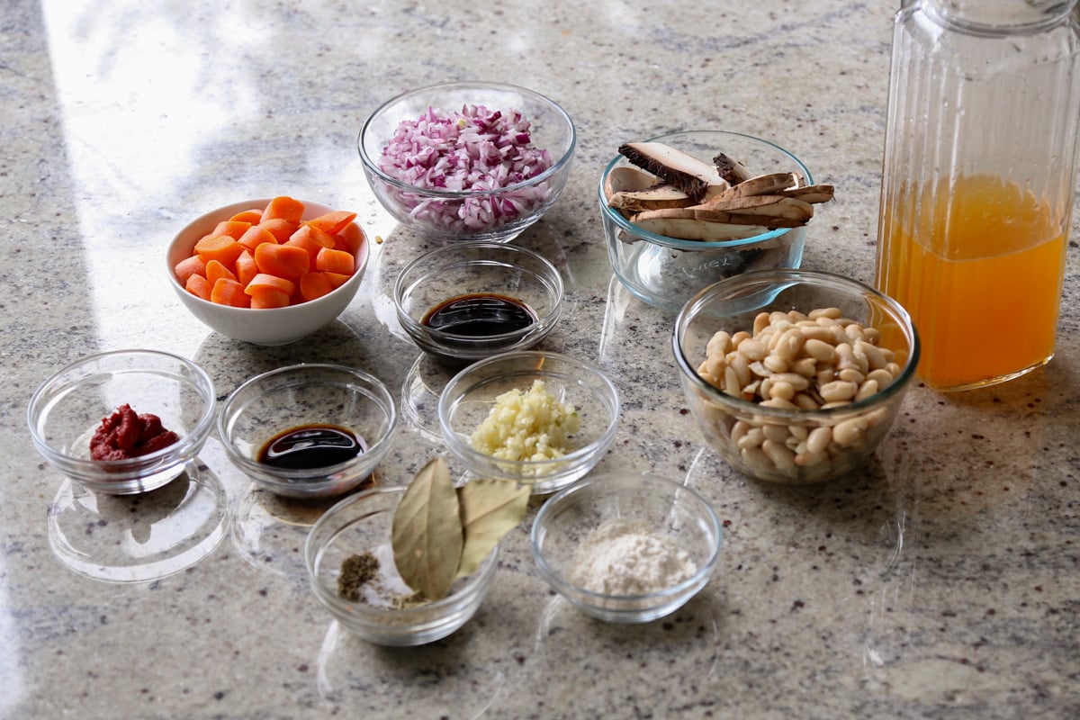 veggie white bean stew ingredients in bowls on the kitchen counter