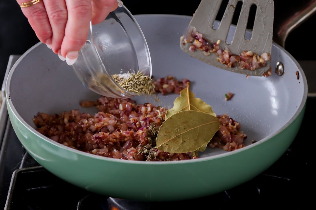 adding herbs to the pan