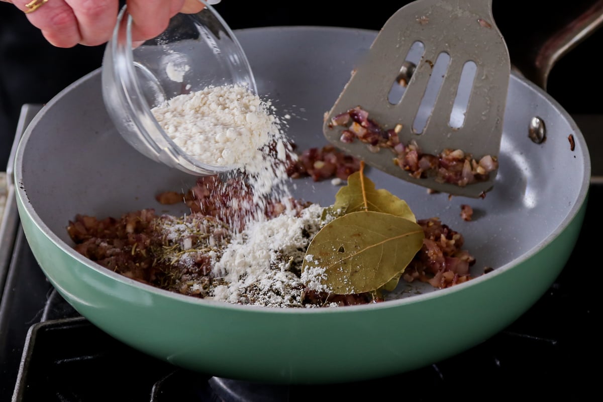 adding flour to the pan