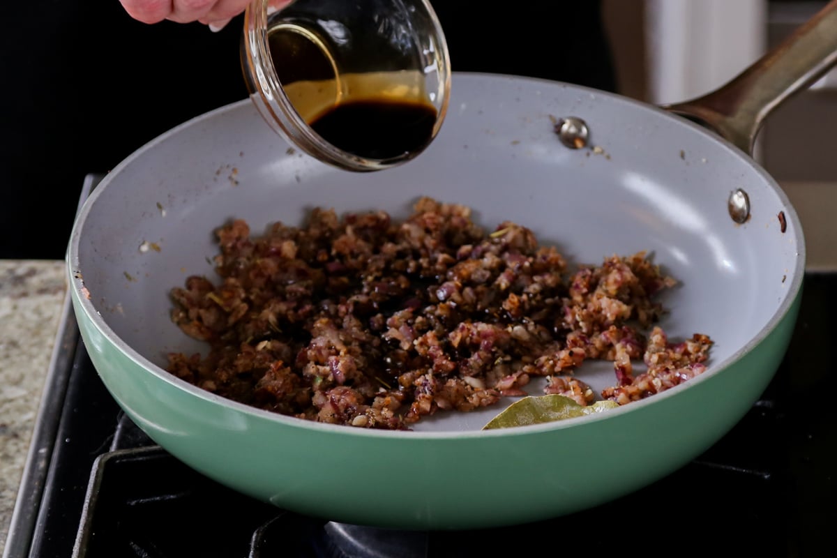 adding soy sauce to the pan