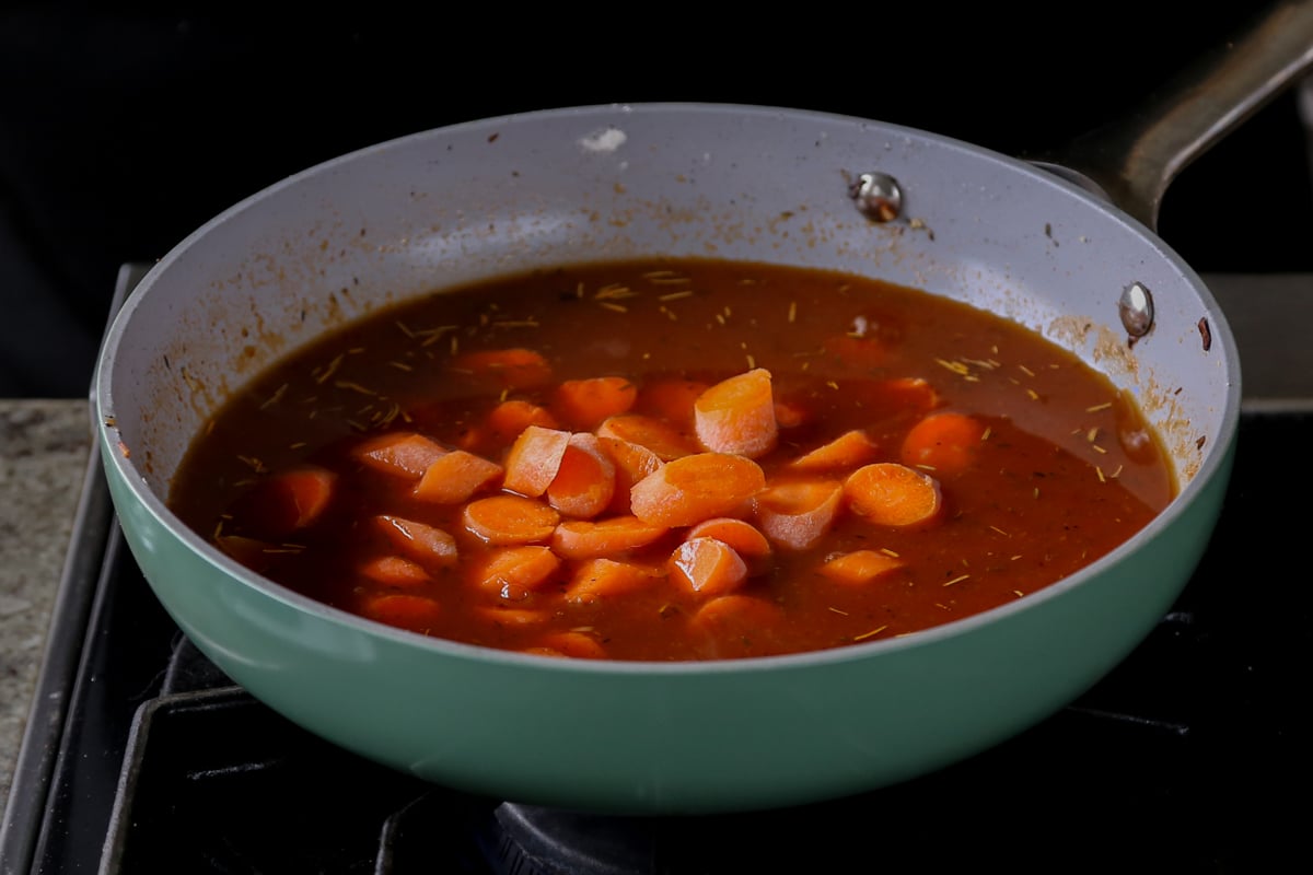 adding carrots to the pan