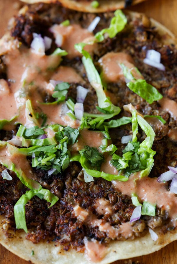 close-up of a vegan smash burger taco with butter chicken sauce