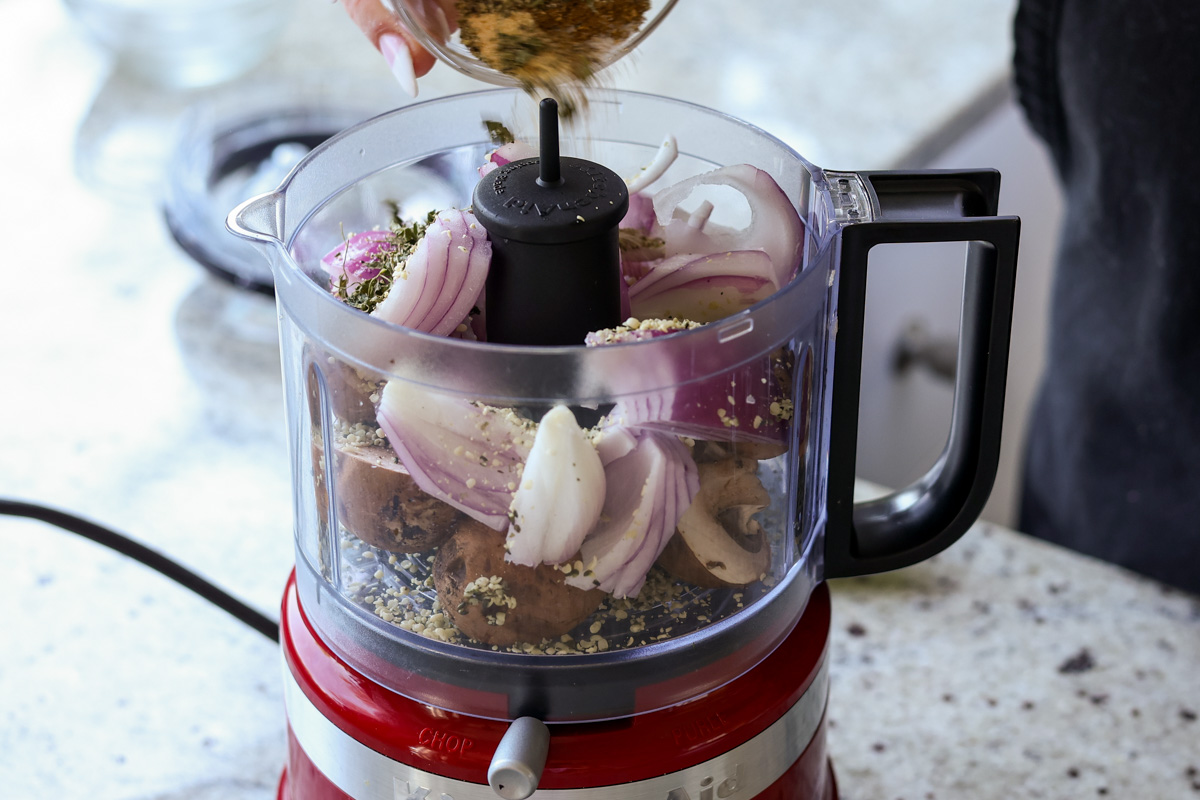 adding lentil meat ingredients to the food processor