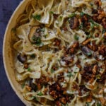 chili miso pasta in a bowl after topping with mushrooms and tofu crumbles