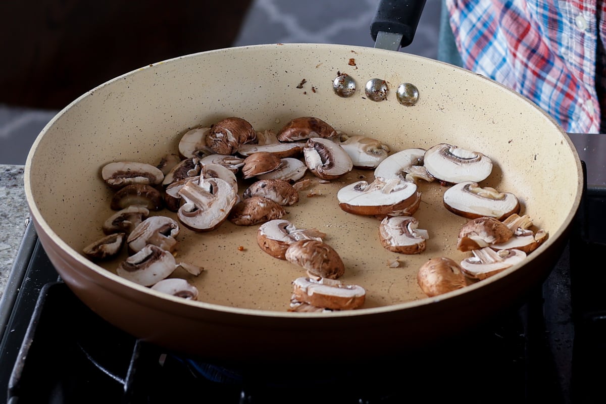adding mushrooms to the pan