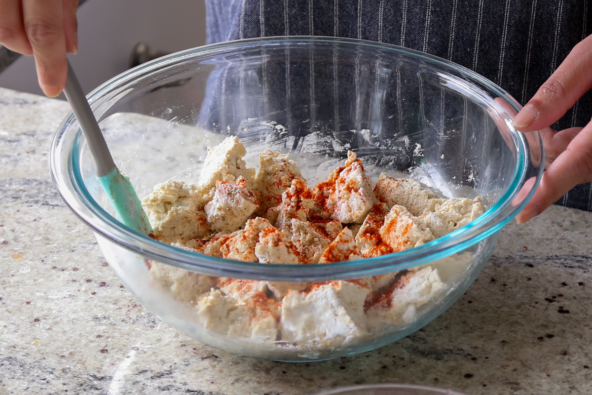 tossing tofu with all of the spices