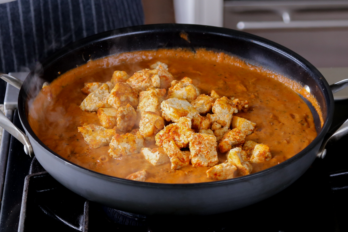 adding tofu to the angara curry sauce