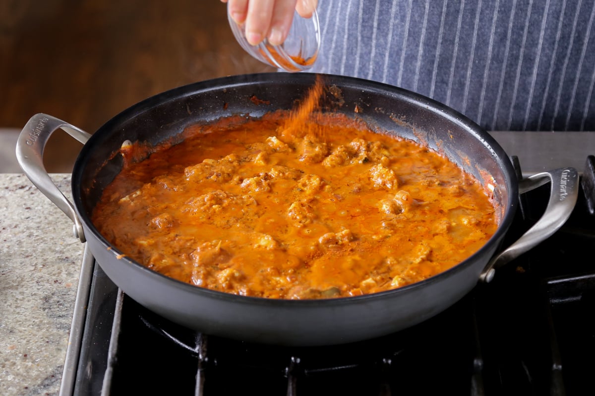 topping the curry with smoked paprika