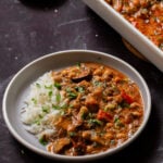 chickpea zucchini curry in a bowl next to the baking pan