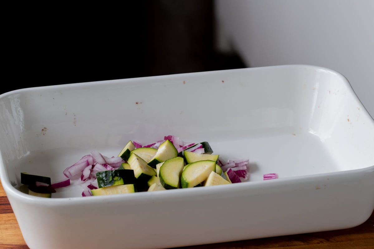 adding onion and zucchini to the pan