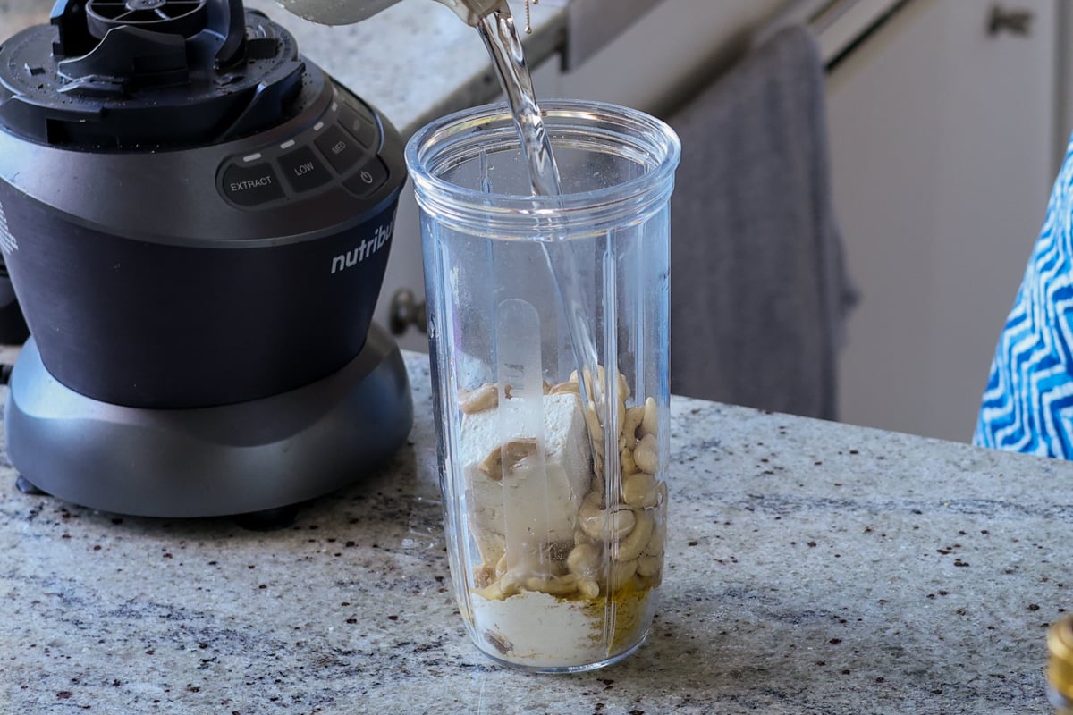 adding cream sauce ingredients to the blender