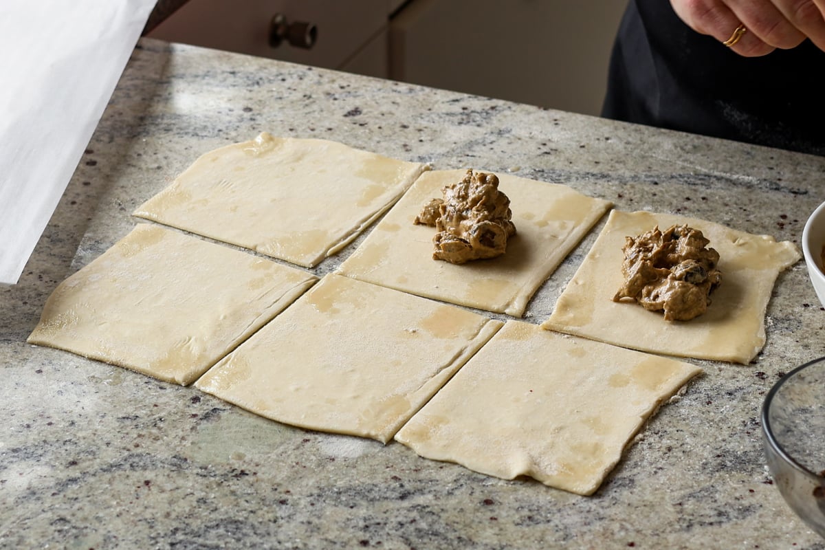 adding creamy mushrooms to the puff pastry